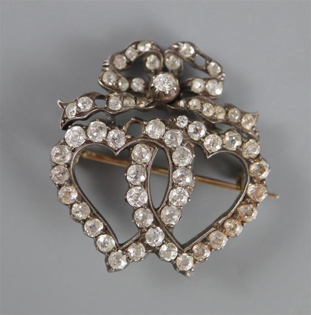 A Victorian gold, silver and diamond cluster set entwined twin hearts brooch,